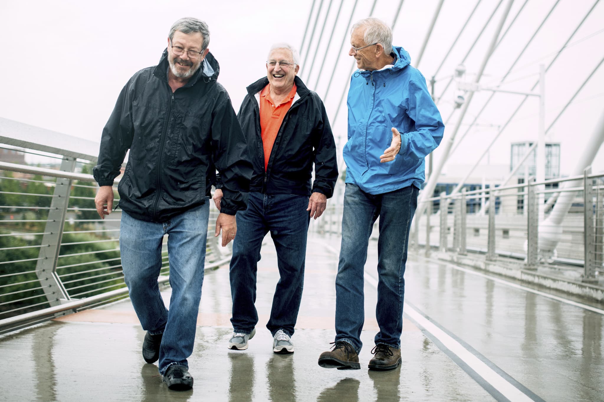Men walking town a rainy street